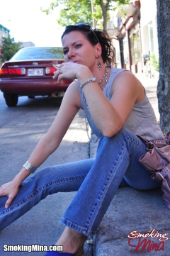 Brunette babe smoking while loitering on the street - N