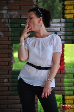 Brunette babe smoking against the wall - N