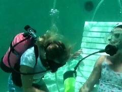 Scuba woman tied in chair underwater