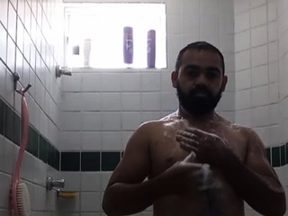 A guy with big pubic hair taking a shower